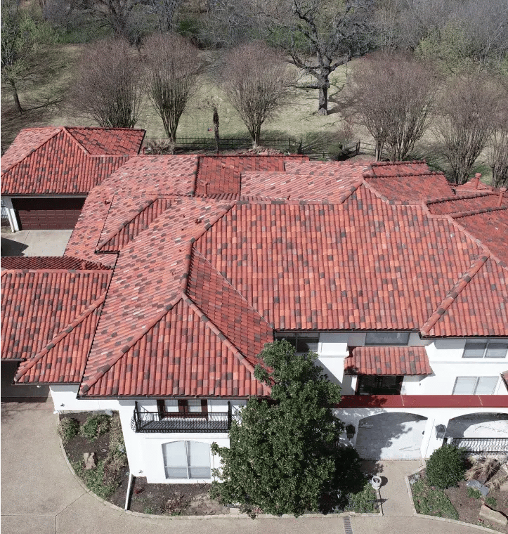 Aerial view of large home with new tile roof. 